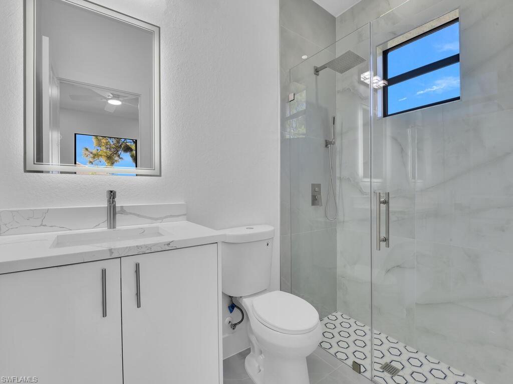 2212-2214 Wilson Road Lehigh Acres, FL 33973 - Photo 41 of 49 a bathroom with a sink toilet and shower