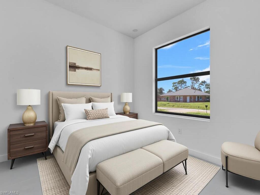 2212-2214 Wilson Road Lehigh Acres, FL 33973 - Photo 42 of 49 a bedroom with a bed and a painting on the wall