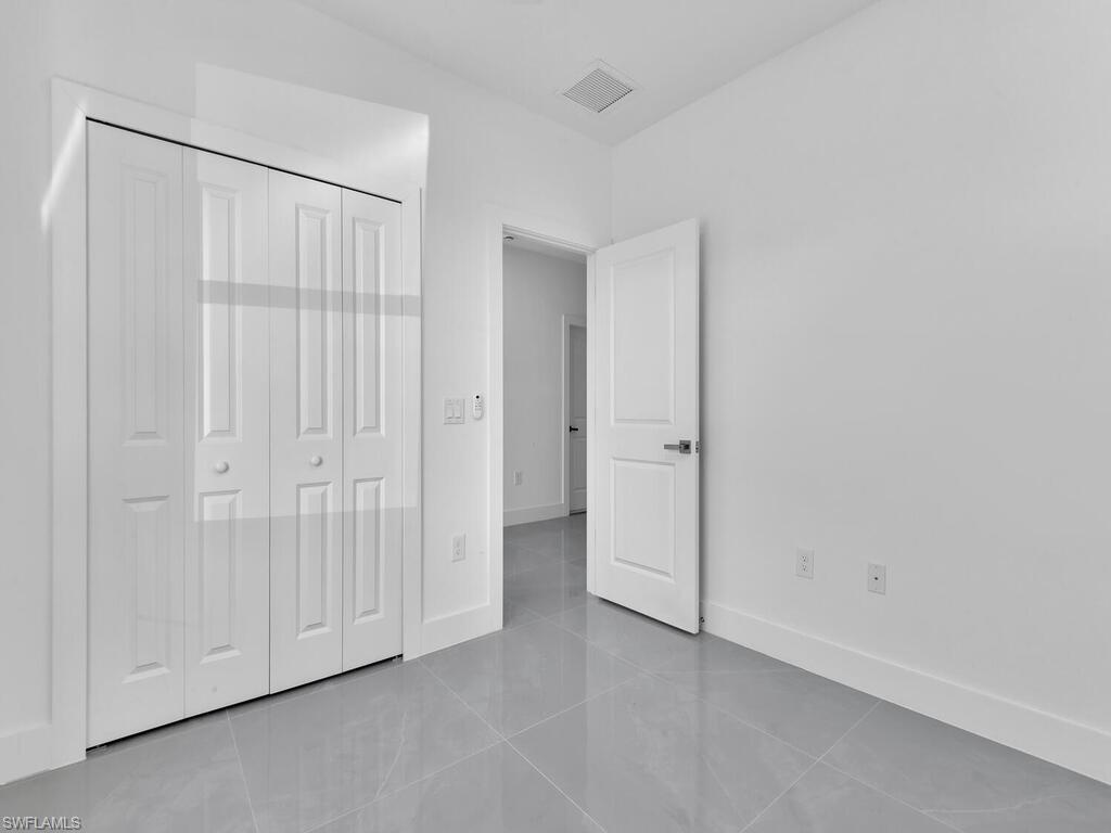 2212-2214 Wilson Road Lehigh Acres, FL 33973 - Photo 44 of 49 an empty room with a hallway