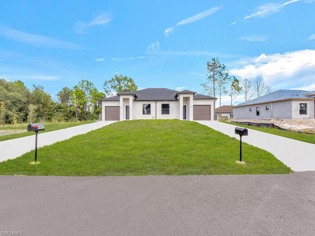 2212-2214 Wilson Road Lehigh Acres, FL 33973 - Photo 49 of 49 a house view with a garden space