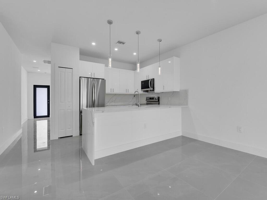 2212-2214 Wilson Road Lehigh Acres, FL 33973 - Photo 6 of 49 a view of a kitchen with electric appliances