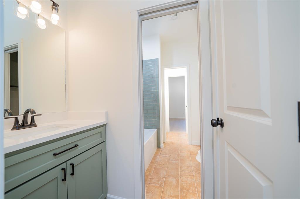711 King Charles Road Scroggins, TX 75480 - Photo 12 of 39 a bathroom with a sink a mirror and shower