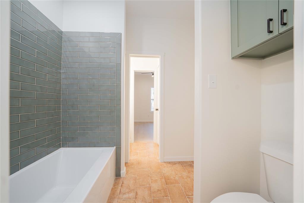 711 King Charles Road Scroggins, TX 75480 - Photo 13 of 39 a bathroom with a granite countertop bathtub shower and toilet