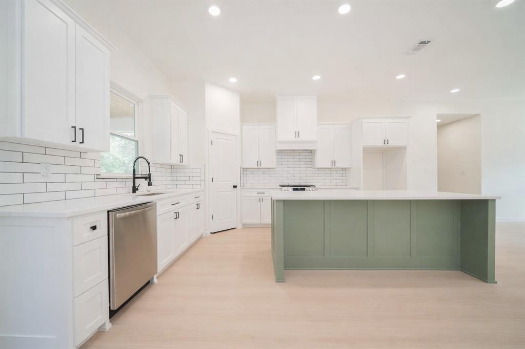 711 King Charles Road Scroggins, TX 75480 - Photo 5 of 39 a kitchen with stainless steel appliances kitchen island granite countertop a sink and cabinets