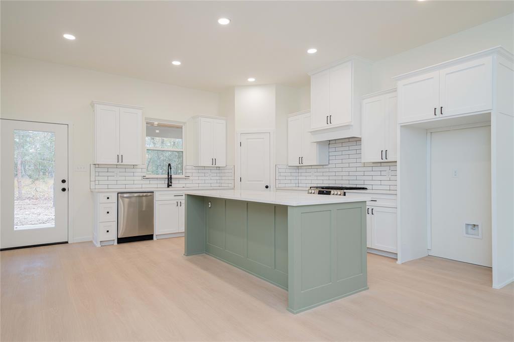 711 King Charles Road Scroggins, TX 75480 - Photo 6 of 39 a kitchen with a white stove top oven and cabinets