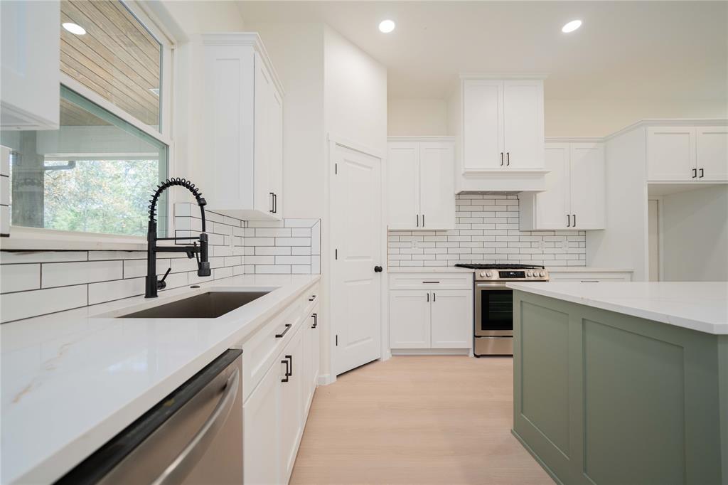 711 King Charles Road Scroggins, TX 75480 - Photo 7 of 39 a kitchen with white cabinets a sink and appliances