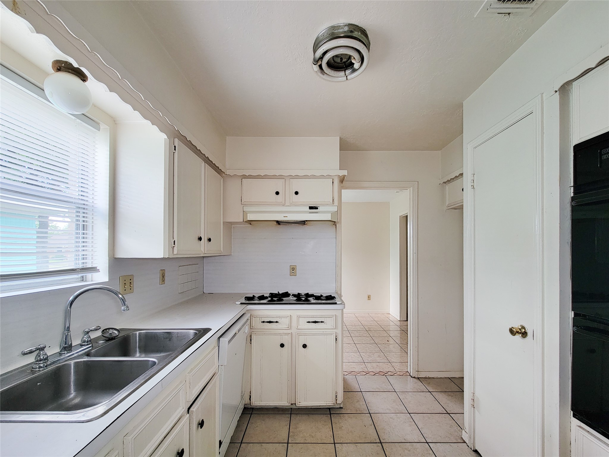 12215 Pompano Lane Houston, TX 77072 - Photo 19 of 44 a kitchen with a sink a stove and cabinets