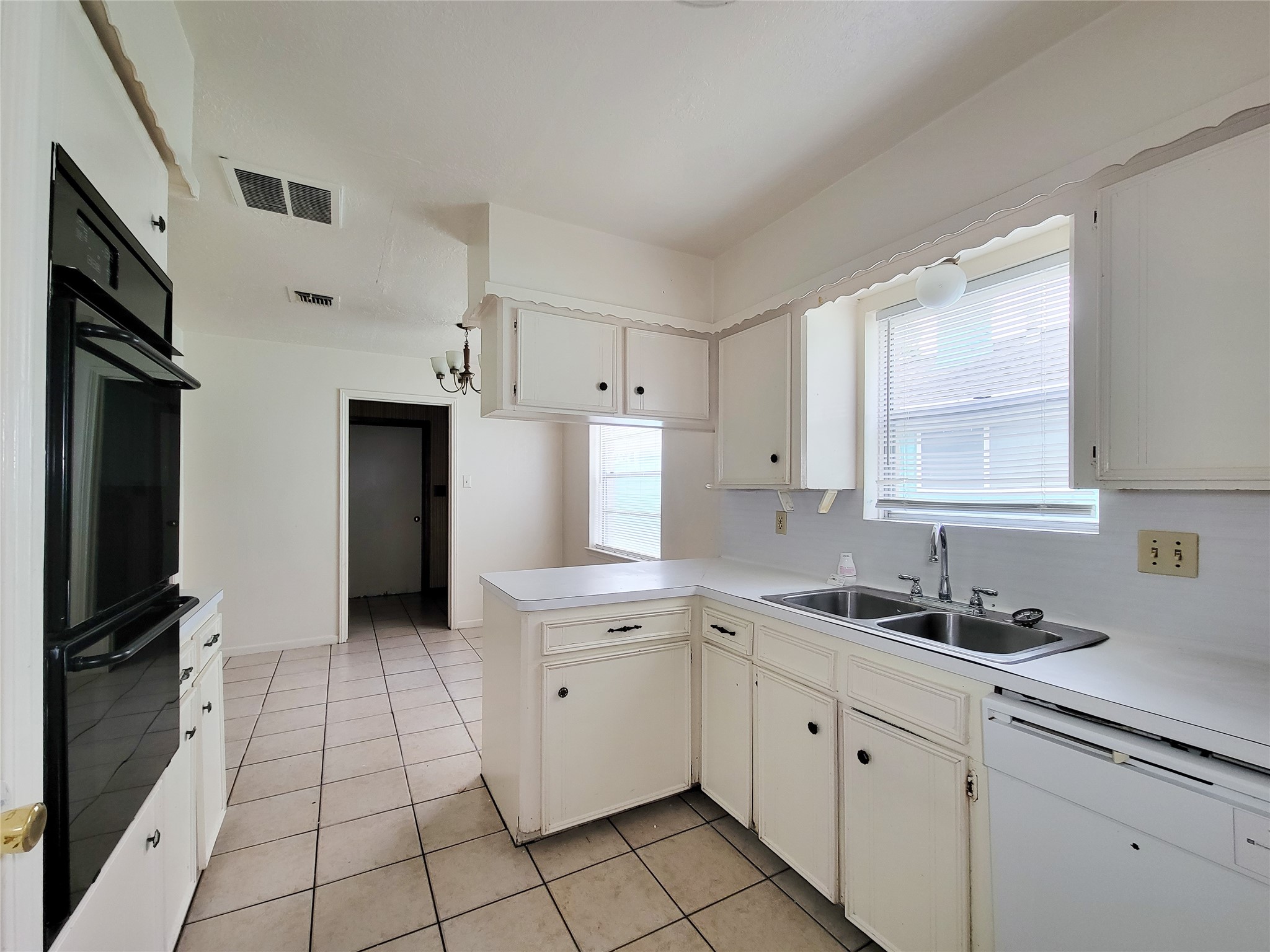 12215 Pompano Lane Houston, TX 77072 - Photo 21 of 44 a kitchen with a sink a refrigerator and cabinets
