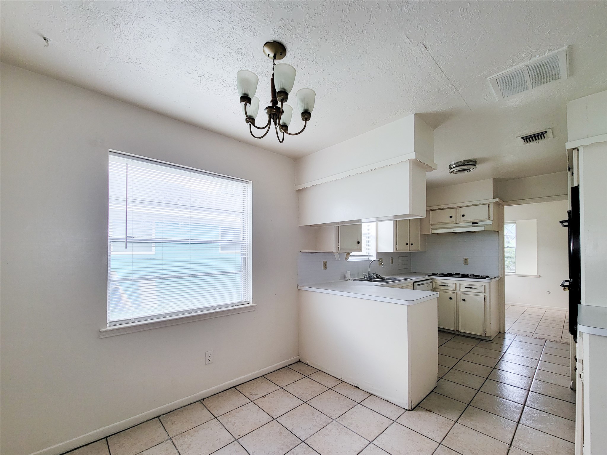 12215 Pompano Lane Houston, TX 77072 - Photo 24 of 44 a kitchen with a stove a sink and a refrigerator
