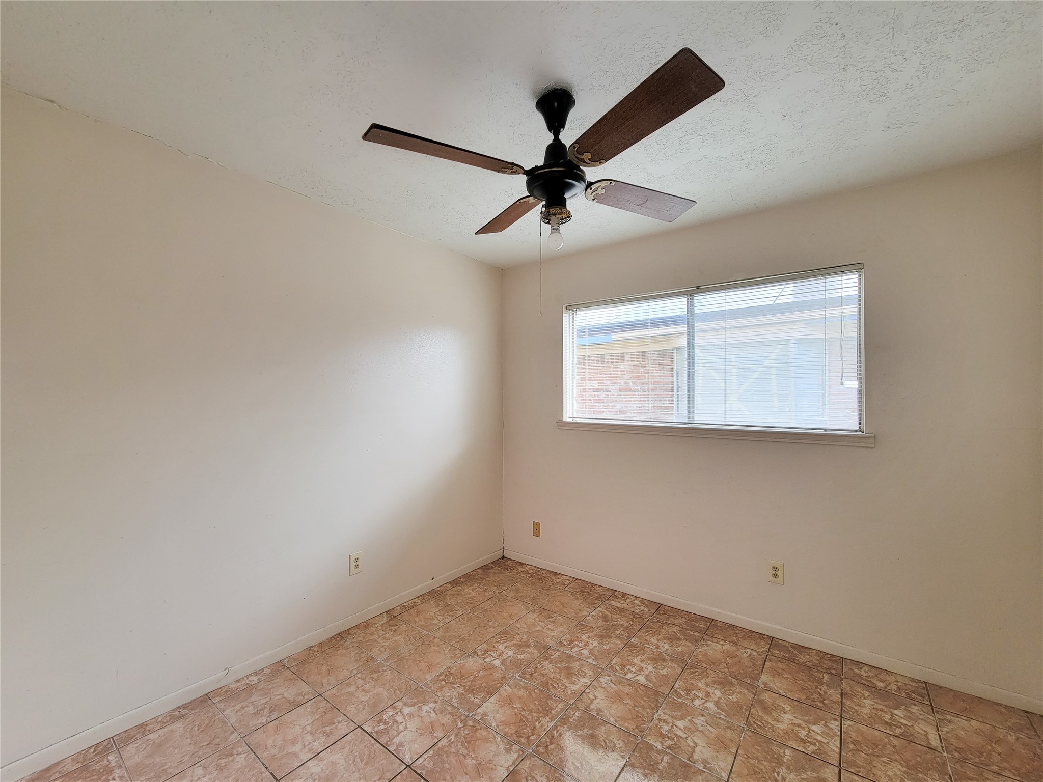 12215 Pompano Lane Houston, TX 77072 - Photo 35 of 44 an empty room with a window and a fan