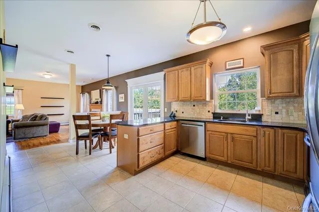 a large kitchen with cabinets table and chairs