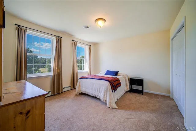 a spacious bedroom with a bed and a table in it