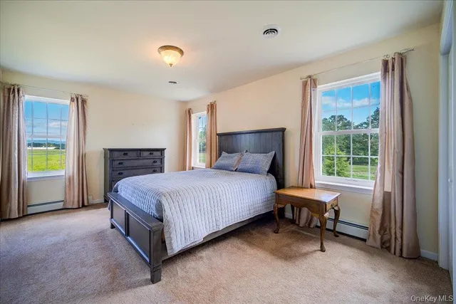 a spacious bedroom with a bed and a window