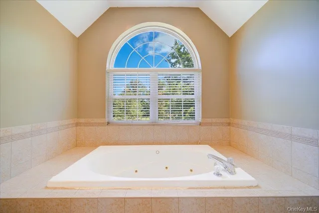 a bathroom with a bathtub and window