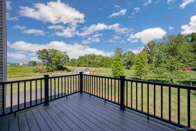 a view of a balcony with wooden floor