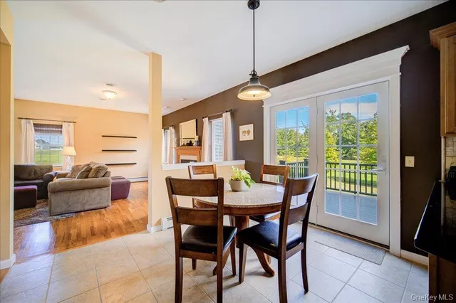 a dining room with furniture a chandelier and a rug