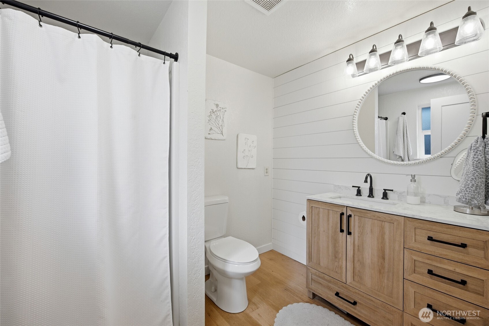 5725 58th Court Southeast Lacey, WA 98513 - Photo 29 of 36 a bathroom with a toilet a sink and a mirror