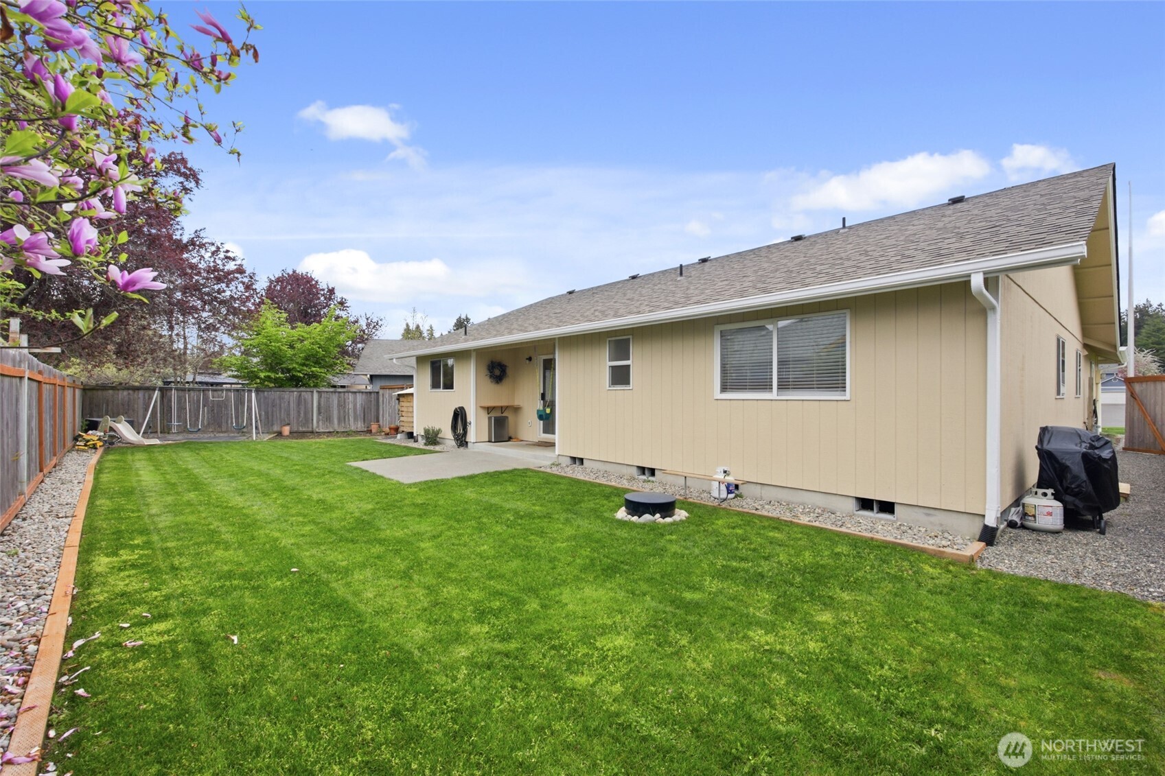 5725 58th Court Southeast Lacey, WA 98513 - Photo 33 of 36 a backyard of a house with table and chairs