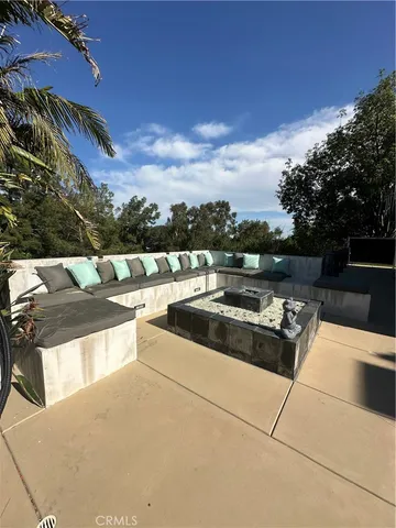 a view of roof deck with couches and sky view