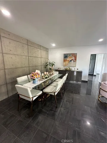 a living room with furniture a rug and a painting on the wall