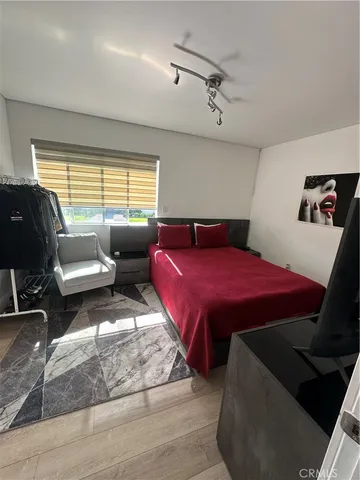 a bedroom with bed couch and window