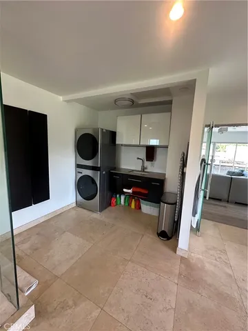 a view of a livingroom with entryway flat screen tv wooden closet and windows