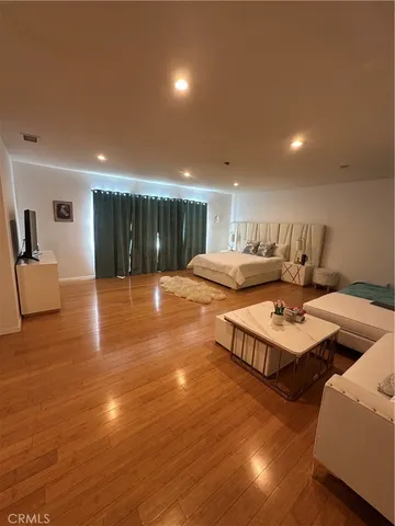 a living room with hard wood flooring and furniture