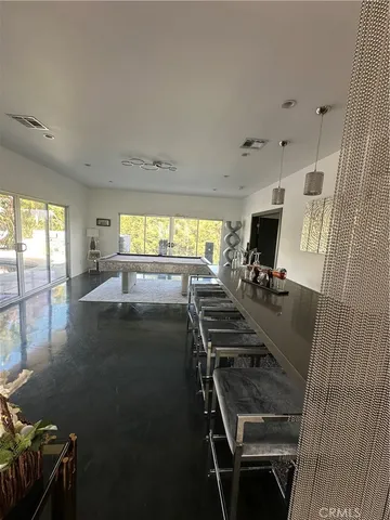 a view of a livingroom with furniture and a floor to ceiling window