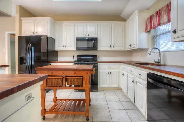 a kitchen with stainless steel appliances granite countertop a refrigerator sink and cabinets