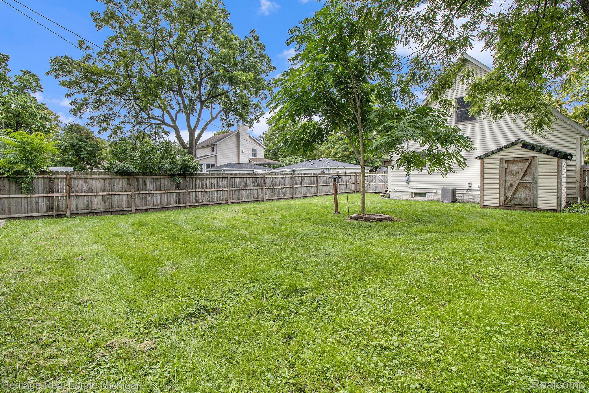 604 West Clinton Street Howell, MI 48843 - Photo 21 of 29 Fenced in backyard with shed