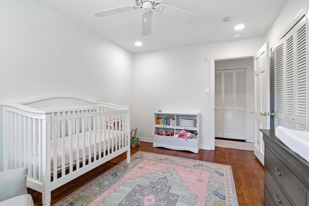 11439 Rosser Road Dallas, TX 75229 - Photo 26 of 35 a bedroom with furniture and baby crib