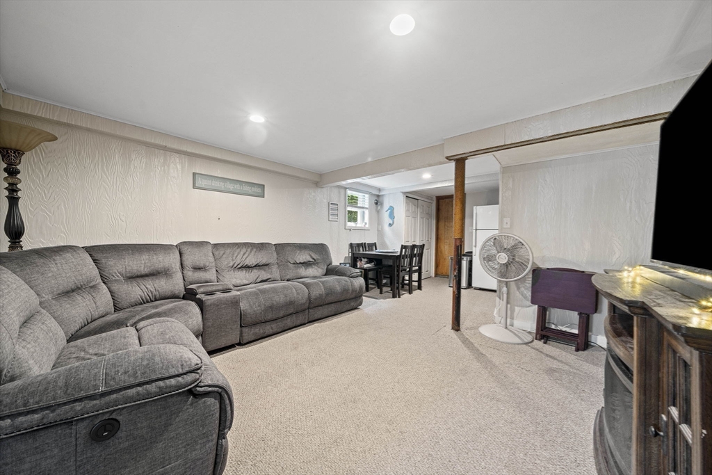 15 D Street Hull, MA 02045 - Photo 16 of 42 a living room with furniture a couch and a flat screen tv