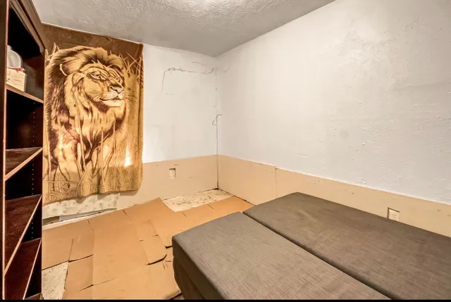 a bed sitting in a bathroom next to a blue wall