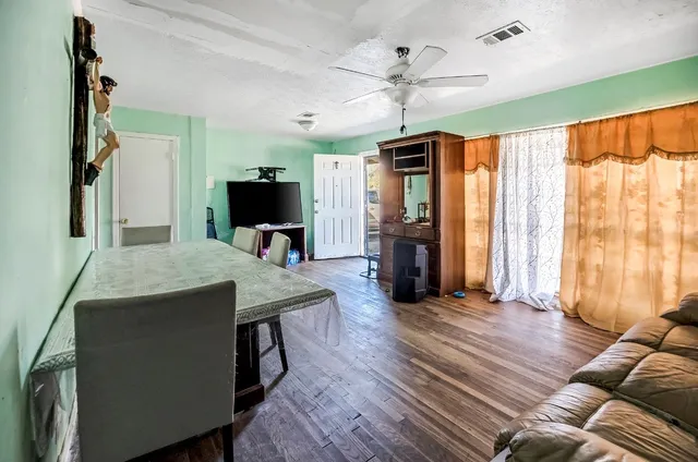 a view of a livingroom with furniture window and wooden floor