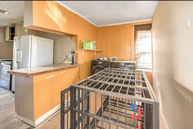 a kitchen with a stove and a refrigerator