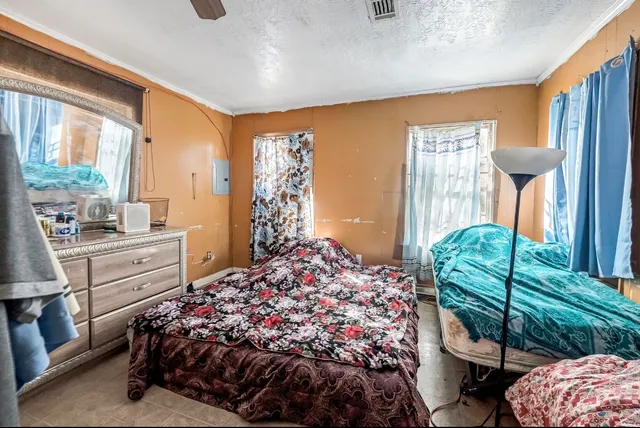 a large bed sitting in a bedroom next to a window