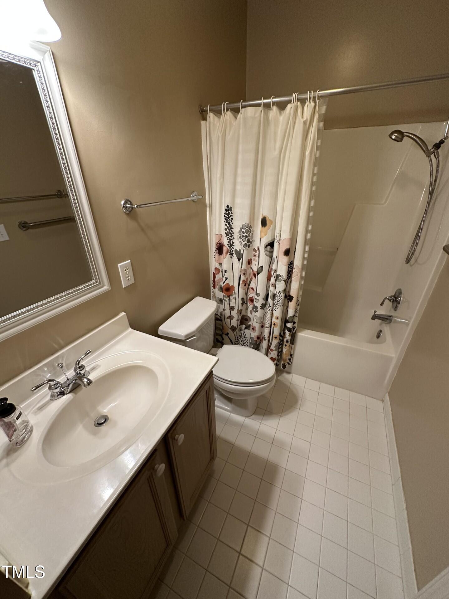 710 North Person Street, Unit 103 Raleigh, NC 27604 - Photo 14 of 16 a bathroom with a sink a toilet and shower