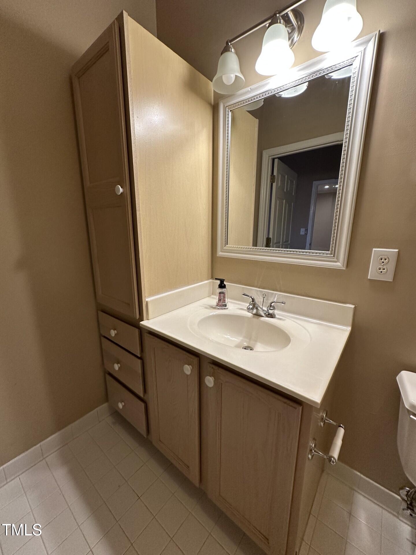 710 North Person Street, Unit 103 Raleigh, NC 27604 - Photo 15 of 16 a bathroom with a sink and a mirror