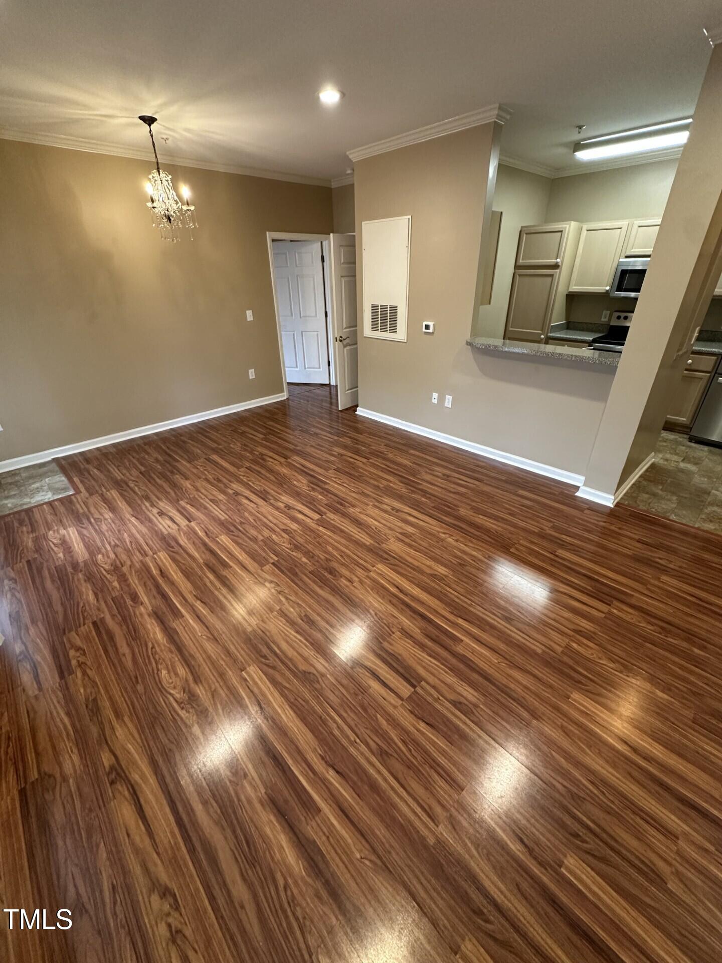 710 North Person Street, Unit 103 Raleigh, NC 27604 - Photo 5 of 16 a view of a room with wooden floor