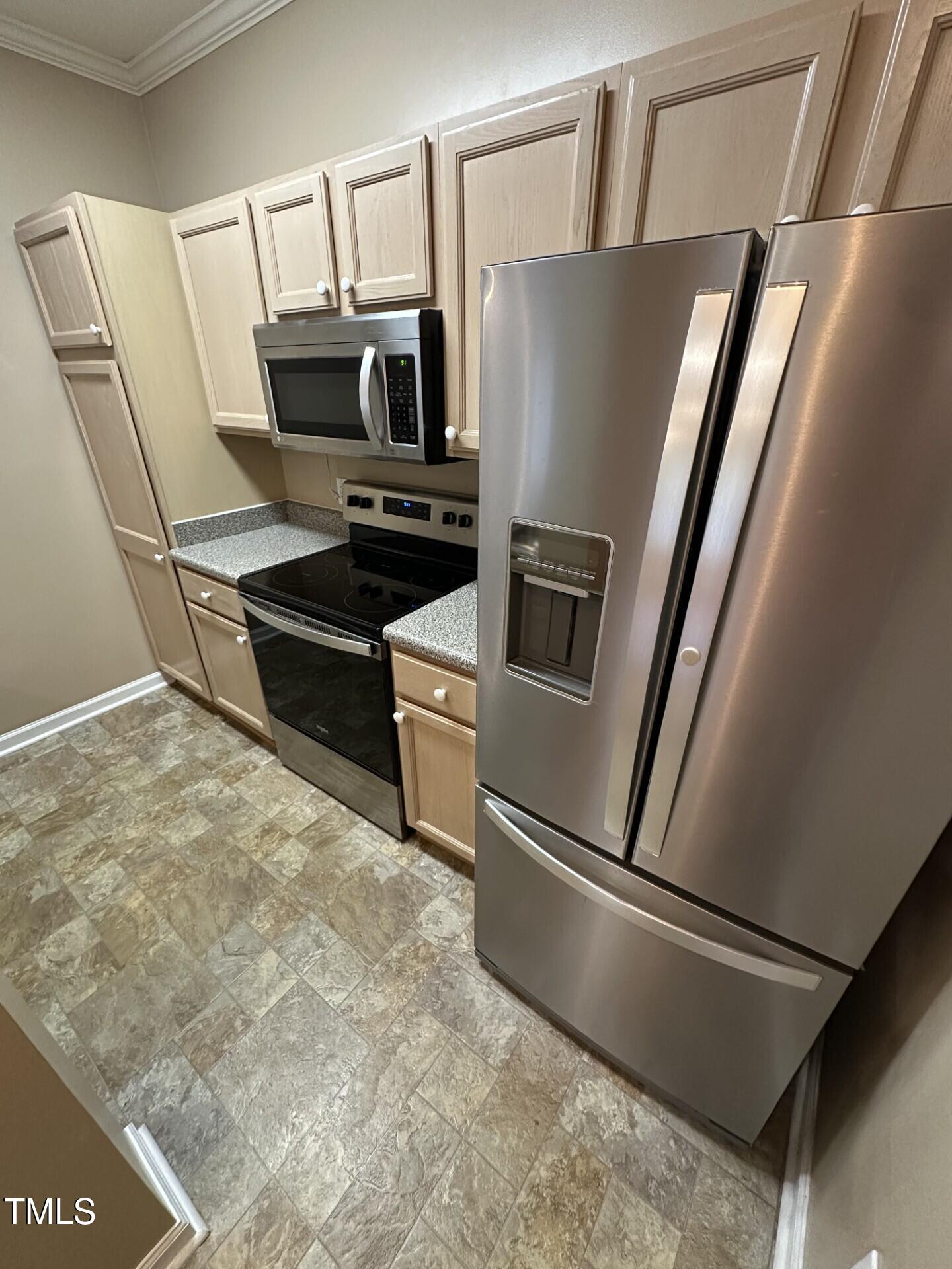 710 North Person Street, Unit 103 Raleigh, NC 27604 - Photo 7 of 16 a kitchen with stainless steel appliances a refrigerator and a stove