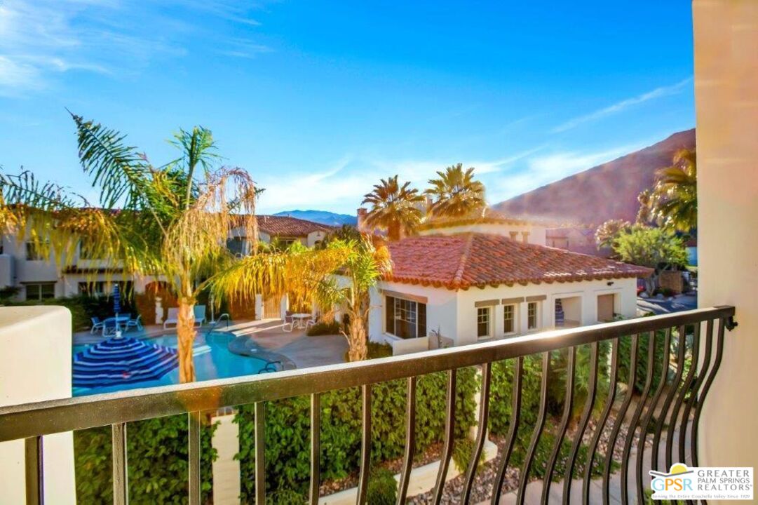 435 Copper Canyon Road, Unit 23 Palm Springs, CA 92262 - Photo 18 of 28 a balcony with wooden floor and fence