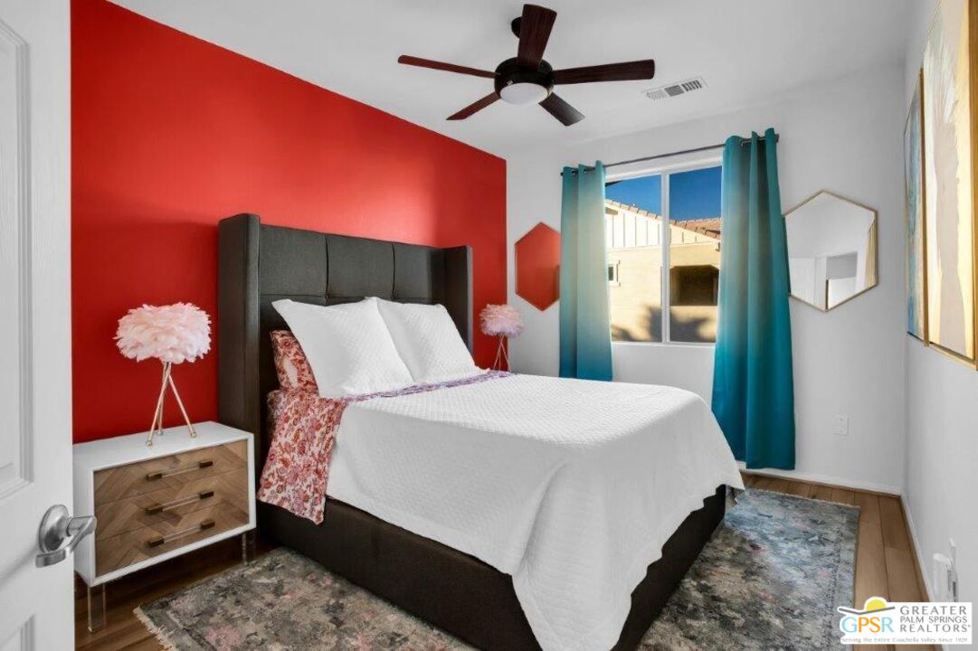 435 Copper Canyon Road, Unit 23 Palm Springs, CA 92262 - Photo 19 of 28 a bedroom with a bed and a chandelier