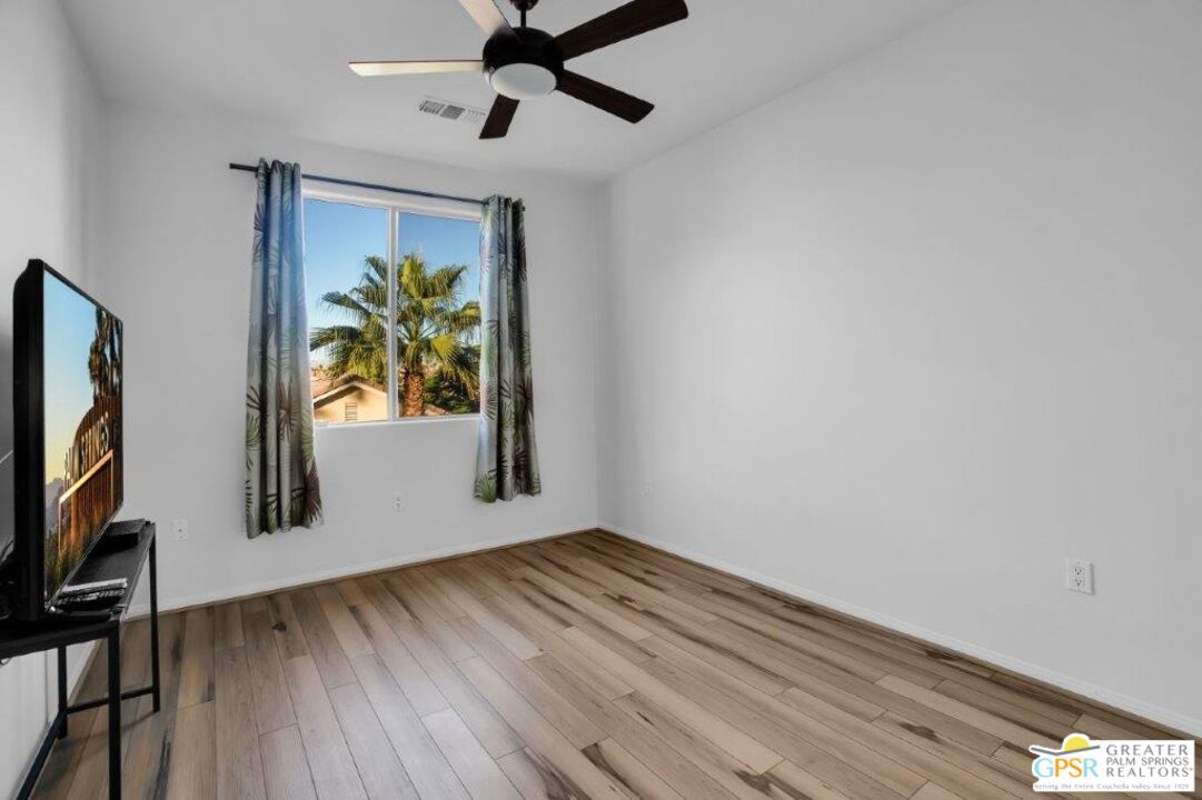 435 Copper Canyon Road, Unit 23 Palm Springs, CA 92262 - Photo 20 of 28 a view of empty room with window and wooden floor