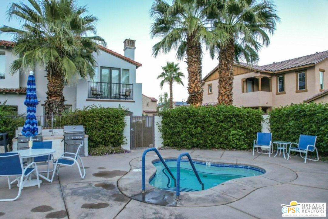 435 Copper Canyon Road, Unit 23 Palm Springs, CA 92262 - Photo 26 of 28 a view of a backyard with a patio and a fire pit