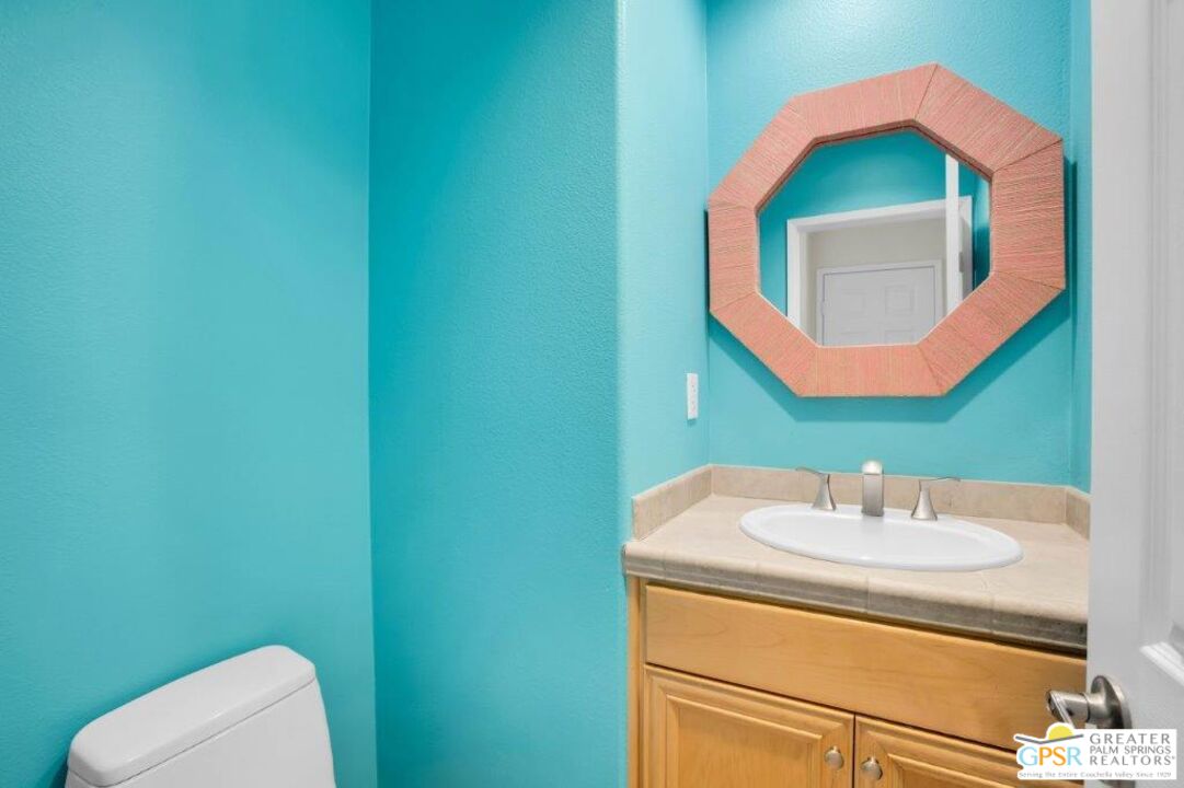 435 Copper Canyon Road, Unit 23 Palm Springs, CA 92262 - Photo 10 of 28 a bathroom with a sink toilet and mirror