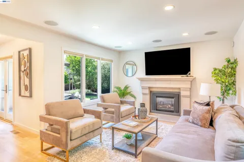 a kitchen with stainless steel appliances granite countertop a stove a sink dishwasher and a dining table with garden view