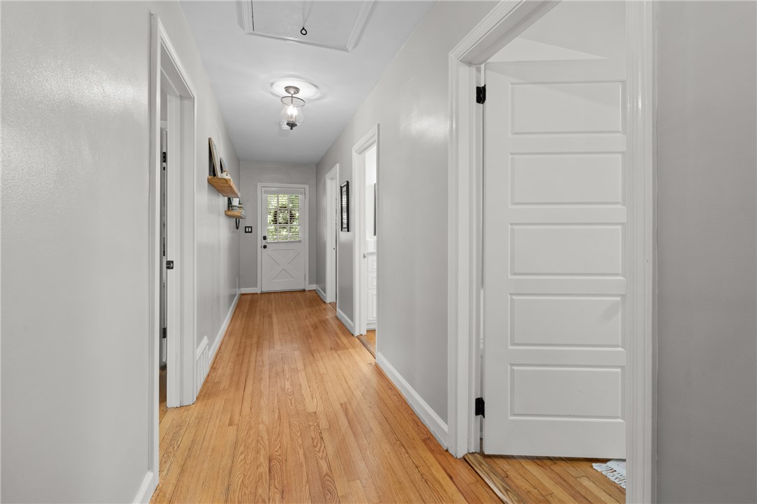 203 Augusta Road Clemson, SC 29631 - Photo 16 of 31 Rich hardwood flooring guides you through this functional hallway, connecting living spaces with ease.