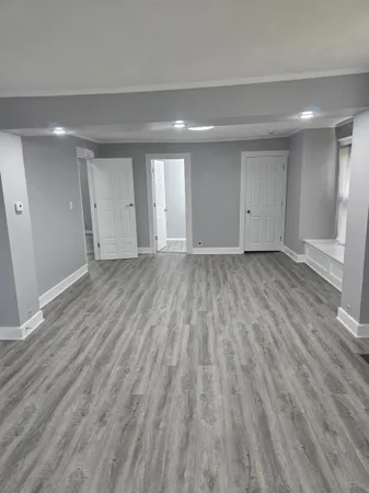 a view of an empty room and wooden floor