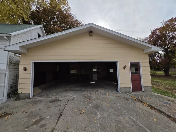 a view of a house with a yard and garage
