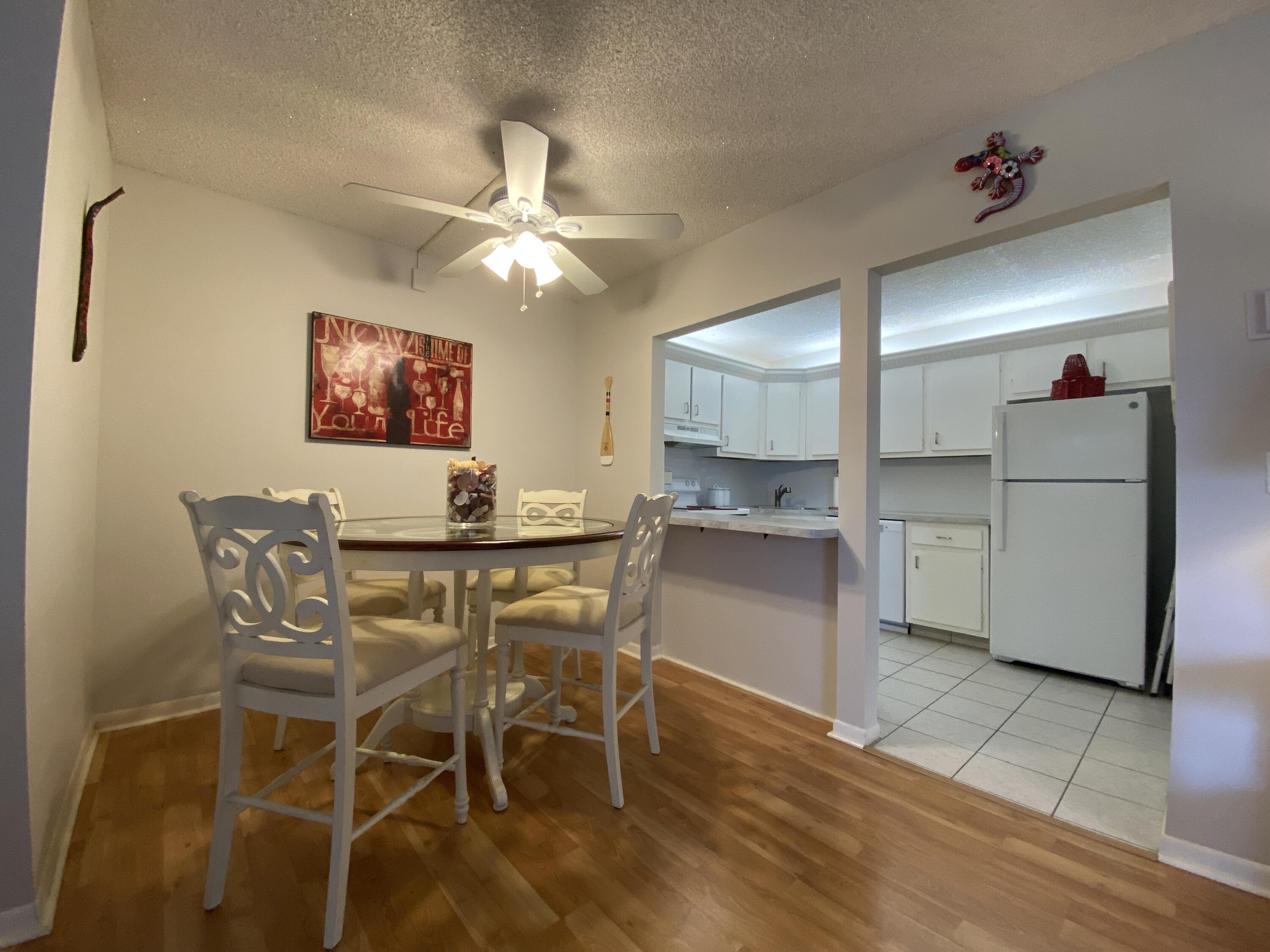 302 Pine Ridge Circle, Unit D1 Greenacres, FL 33463 - Photo 11 of 46 a view of a dining room with furniture and a chandelier